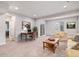 Open-concept living room boasts a desk, comfortable seating, carpeted floor, and bright lighting at 1168 Basalt Ridge Loop, Castle Rock, CO 80108