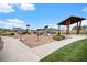 Community playground featuring slides, covered seating and lush landscaping under a bright sunny sky at 1168 Basalt Ridge Loop, Castle Rock, CO 80108