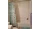 Bathroom with shower/tub combo and teal shower curtain at 6845 S Webster St # E, Littleton, CO 80128