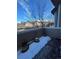 Small deck with potted plants and some snow on it at 6845 S Webster St # E, Littleton, CO 80128