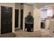 Entryway with black door, corner aquarium, and view into living area at 6845 S Webster St # E, Littleton, CO 80128