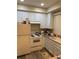 Bright kitchen featuring white cabinets and wood-look floors at 6845 S Webster St # E, Littleton, CO 80128
