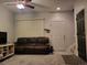 Living room with brown couch, TV stand, and carpeted floor at 6845 S Webster St # E, Littleton, CO 80128