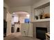 Living room with fireplace and view of kitchen at 6845 S Webster St # E, Littleton, CO 80128