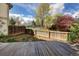 Inviting backyard with a wooden deck, fence, and community tennis court, perfect for outdoor relaxation and recreation at 7970 W 90Th Ave # 115, Broomfield, CO 80021