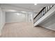 Spacious basement with carpet, columns, stairway, and ample room for recreation and potential customization at 7970 W 90Th Ave # 115, Broomfield, CO 80021
