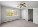 Serene bedroom with plush carpet, ceiling fan, double closet, and a window offering natural light and backyard views at 7970 W 90Th Ave # 115, Broomfield, CO 80021