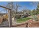 The large, landscaped backyard offers a charming rope swing and spacious area for outdoor enjoyment at 6487 W Weaver Ave, Littleton, CO 80123