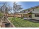 Enjoy the well-maintained backyard featuring a covered patio and lush greenery at 6487 W Weaver Ave, Littleton, CO 80123
