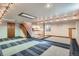 Open basement area offering a versatile space with a kitchenette, ample lighting and unique carpet design at 6487 W Weaver Ave, Littleton, CO 80123