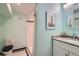 This updated bathroom has a modern vanity with granite countertop and walk-in shower at 6487 W Weaver Ave, Littleton, CO 80123