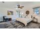 A tranquil bedroom with a comfy bed, ceiling fan, and tasteful decor creates a relaxing retreat at 6487 W Weaver Ave, Littleton, CO 80123