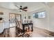 Bright dining room featuring hardwood floors, a modern ceiling fan, and sliding glass doors to the outdoor space at 6487 W Weaver Ave, Littleton, CO 80123