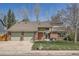 Attractive two-story home with brick accents, a tiled roof, and a spacious two-car garage at 6487 W Weaver Ave, Littleton, CO 80123