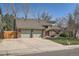 Two-story home with a brick facade, a two-car garage, and a neatly landscaped front yard at 6487 W Weaver Ave, Littleton, CO 80123