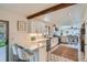 Modern kitchen featuring white cabinets, stainless steel appliances, and a breakfast bar at 6487 W Weaver Ave, Littleton, CO 80123