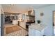 Contemporary kitchen with stainless steel appliances, a range hood, and ample counter space at 6487 W Weaver Ave, Littleton, CO 80123