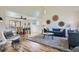 Bright and airy living room featuring hardwood floors, a vaulted ceiling, and stylish furniture at 6487 W Weaver Ave, Littleton, CO 80123