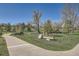 A peaceful park setting, including Weaver Park benches, a walkway and a well maintained lawn at 6487 W Weaver Ave, Littleton, CO 80123