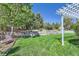 Beautiful backyard featuring a lush lawn, retaining wall, and mature trees for added privacy at 2261 Bulrush Ct, Castle Rock, CO 80109