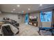 Large finished basement with lounge area, sliding glass doors, and workout space at 781 Deer Clover Cir, Castle Pines, CO 80108