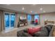 Finished basement featuring a lounge area, tv, workout space and sliding glass doors at 781 Deer Clover Cir, Castle Pines, CO 80108