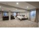 Spacious basement with a lounge area, a bed and natural light at 781 Deer Clover Cir, Castle Pines, CO 80108