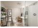 Clean bathroom with a shower, mirrored wall, and storage shelves at 781 Deer Clover Cir, Castle Pines, CO 80108