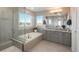 Bright bathroom showcases a soaking tub, glass-enclosed shower, and double vanity at 781 Deer Clover Cir, Castle Pines, CO 80108