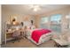 Cozy bedroom featuring a comfortable bed, a study desk and bright sunlight from the windows at 781 Deer Clover Cir, Castle Pines, CO 80108