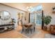 Open-concept dining area features hardwood floors, high ceilings, a dining table and bright natural light with view of kitchen at 781 Deer Clover Cir, Castle Pines, CO 80108
