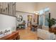 Open-concept dining area features hardwood floors, high ceilings, a dining table and bright natural light with view of kitchen at 781 Deer Clover Cir, Castle Pines, CO 80108