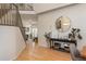 Hallway with hardwood floors leading to a living room and featuring a modern console table with plants and decor at 781 Deer Clover Cir, Castle Pines, CO 80108