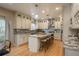 Elegant kitchen featuring a large island with seating and stainless steel appliances at 781 Deer Clover Cir, Castle Pines, CO 80108