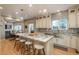 Well-lit kitchen with a center island, stylish pendants, and stainless sink at 781 Deer Clover Cir, Castle Pines, CO 80108