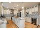 Spacious kitchen with island seating, stainless steel appliances, and hardwood floors at 781 Deer Clover Cir, Castle Pines, CO 80108