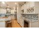 Modern kitchen with custom cabinets, granite counters, and wine storage at 781 Deer Clover Cir, Castle Pines, CO 80108