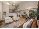 Spacious living room featuring high ceilings, hardwood floors, a staircase, a dining area, and abundant natural light at 781 Deer Clover Cir, Castle Pines, CO 80108