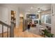 Cozy living room with a fireplace, plush carpet, comfortable seating, and access to a bathroom and bright natural light at 781 Deer Clover Cir, Castle Pines, CO 80108