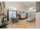 Spacious living room featuring high ceilings, hardwood floors, a dining area, and abundant natural light from multiple windows at 781 Deer Clover Cir, Castle Pines, CO 80108