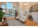 Bright and airy living room with large windows, hardwood floors, high ceilings, and stylish furnishings and staircase at 781 Deer Clover Cir, Castle Pines, CO 80108