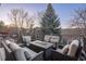 Inviting outdoor patio with a sleek fire table and plush seating, ideal for enjoying serene evenings and neighborhood views at 781 Deer Clover Cir, Castle Pines, CO 80108