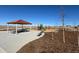Community playground featuring a slide, tables, benches and shade structures at 42996 Colonial Trl, Elizabeth, CO 80107