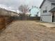 Large backyard with a wooden fence, some grass, and a small patio at 4348 Sable St, Denver, CO 80239