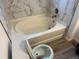 Bathroom featuring a marble tiled wall with a bathtub at 4348 Sable St, Denver, CO 80239