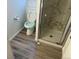 Bathroom featuring marble tiled walls and a shower with a glass door at 4348 Sable St, Denver, CO 80239