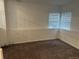 Neutral bedroom featuring carpet flooring and corner windows for ample light at 4348 Sable St, Denver, CO 80239