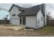 Rear exterior of gray home with sliding glass door to backyard and second story window at 4348 Sable St, Denver, CO 80239