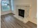 Bright Living Room featuring a modern fireplace and large windows providing natural light at 4348 Sable St, Denver, CO 80239