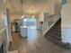 Open floor plan featuring updated floors, a modern kitchen with an island, and a staircase to the second floor at 4348 Sable St, Denver, CO 80239